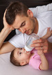 Portrait of father feeding daughter