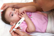 Sick baby being checked for illness.