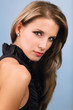 Young attractive woman on blue background