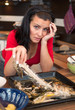 Tired woman cleans up leftovers from lunch