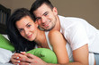 Happy young couple in bed