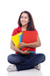 Happy female student sitting on floor with notebooks - isolated