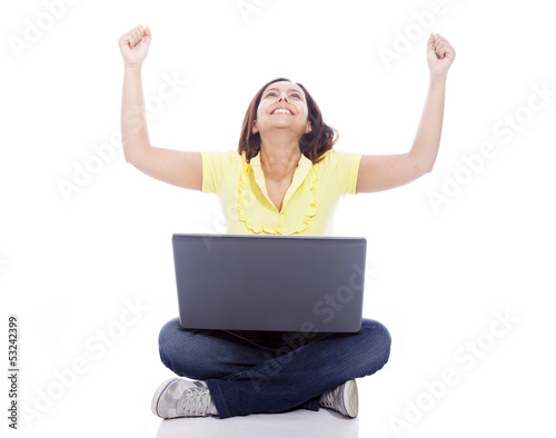 Photo: Happy winner woman with arms raised, sitting on the floor with a Happy winner woman with arms raised, sitting on the floor with a