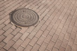 Photo: Round steel sewer manhole on the pavement Round steel sewer manhole on the pavement