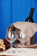 Foto: Wine and glasses on round table on cloth background Wine and glasses on round table on cloth background