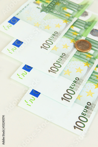 Photo: Euro banknotes and euro cents isolated on white Euro banknotes and euro cents isolated on white