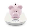 Foto: Piggy bank on scales Piggy bank on scales