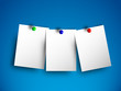 Three white papers on blue wall