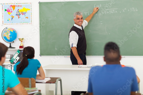 Photo: middle aged teacher teaching mathematics middle aged teacher teaching mathematics