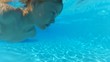 Boy swimming underwater in a pool