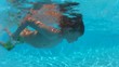 Boy swimming underwater a pool
