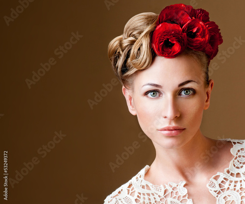 Photo: fashion model with hairstyle and flowers in her hair. fashion model with hairstyle and flowers in her hair.