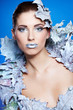 Photo: Young woman in creative image with silver artistic make-up. Young woman in creative image with silver artistic make-up.