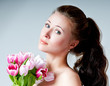 Photo: beautiful girl with a bouquet of tulips beautiful girl with a bouquet of tulips