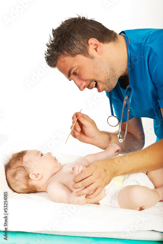 Photo: Doctor examine baby neck for sore throat Doctor examine baby neck for sore throat