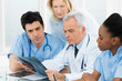 Photo: Doctors Examining X-ray Report Doctors Examining X-ray Report