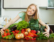 Foto: happy woman with pile of vegetables happy woman with pile of vegetables
