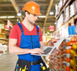 Photo: Portrait of handyman with laptop working warehouse Portrait of handyman with laptop working warehouse
