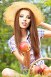 Photo: Apple woman. Very beautiful ethnic model eating red apple in the Apple woman. Very beautiful ethnic model eating red apple in the