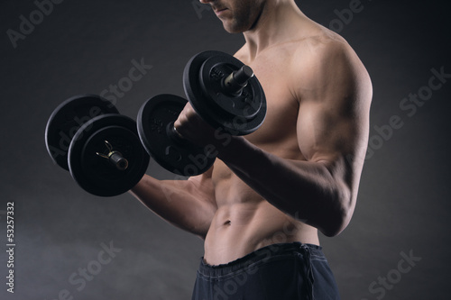 Photo: Exercising biceps with dumbbells Exercising biceps with dumbbells