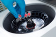 Scientist loading a sample to centrifuge