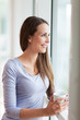 Woman looking through window