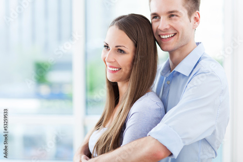 Photo: Couple hugging in new apartment Couple hugging in new apartment