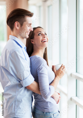 Photo: Couple hugging in new apartment Couple hugging in new apartment