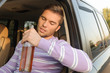 Drunk driver with a bottle of wine