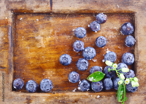 Photo: Close-up of blueberries in an old used wooden tray Close-up of blueberries in an old used wooden tray
