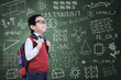 Asian nerd boy with backpack in class