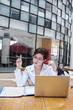 Attractive businesswoman working with laptop at cafe
