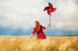Photo: Redhead girl with toy wind turbine Redhead girl with toy wind turbine