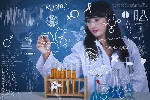 Photo: Beautiful scientist drawing formula at lab Beautiful scientist drawing formula at lab