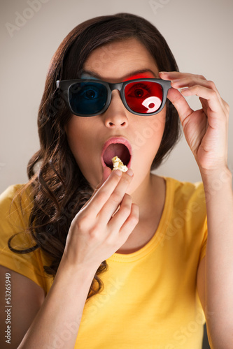 Photo: Shocked young woman watching 3D movie Shocked young woman watching 3D movie