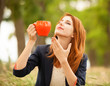 Redhead girl with orange cup at outdoor