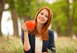 Redhead girl with orange cup at outdoor