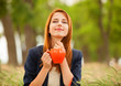 Redhead girl with orange cup at outdoor