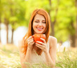 Redhead girl with orange cup at outdoor