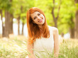 Redhead girl with orange cup at outdoor