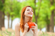 Redhead girl with orange cup at outdoor