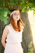 Redhead girl near tree at countryside