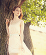 Redhead girl near tree at countryside