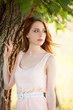 Redhead girl near tree at countryside