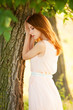 Redhead girl near tree at countryside