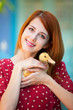 Redhead girl with duck near old house