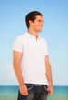 Handsome young man at beach background