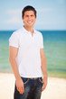 Handsome young man at beach background