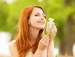 Redhead girl with perfume at outdoor