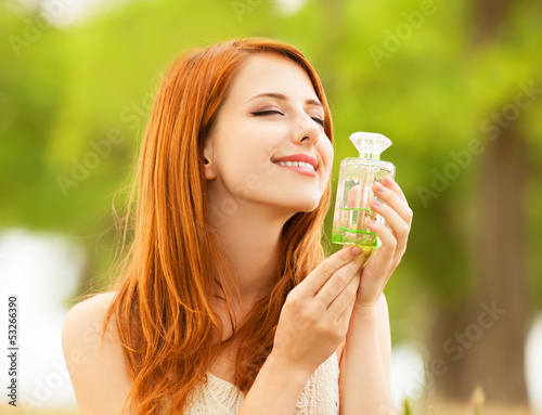 Photo: Redhead girl with perfume at outdoor Redhead girl with perfume at outdoor